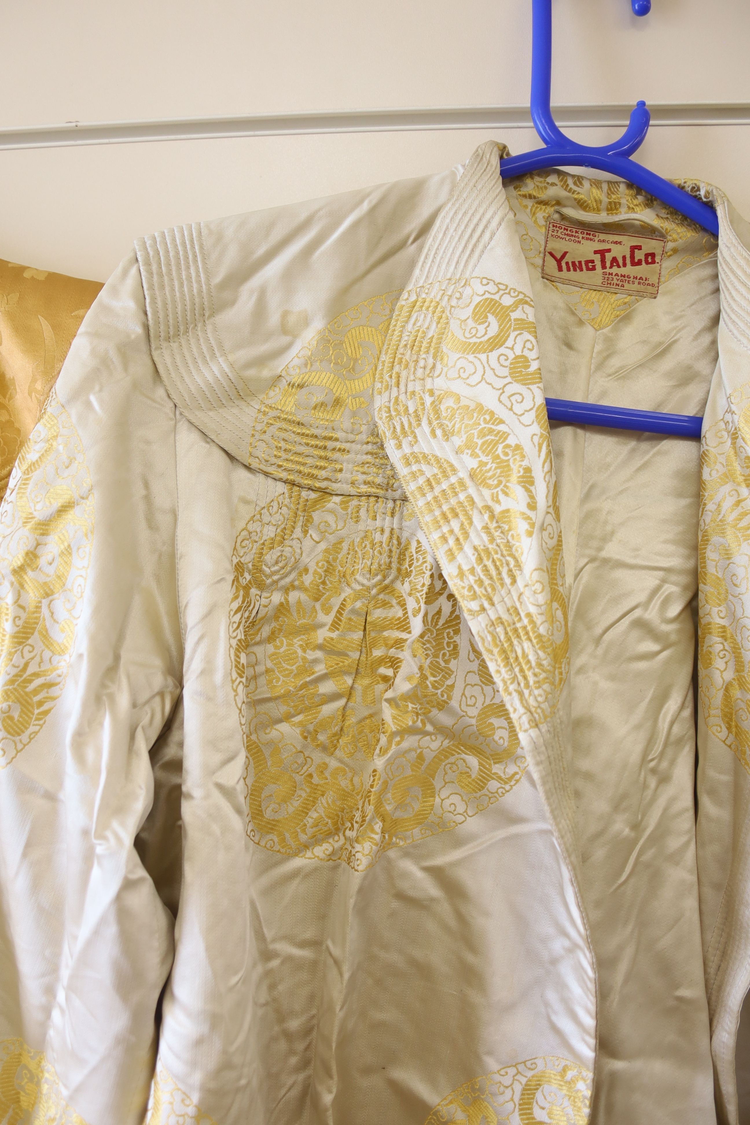 A 1940's Chinese yellow damask jacket, length 87cm, and a similar brocade jacket